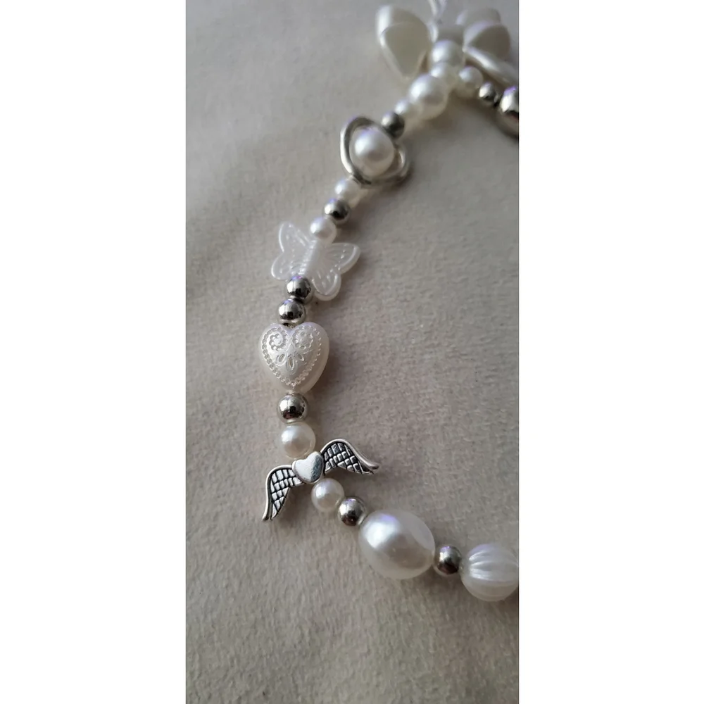 Phone chain with a variety of white & silver-tone beads, including faux pearls